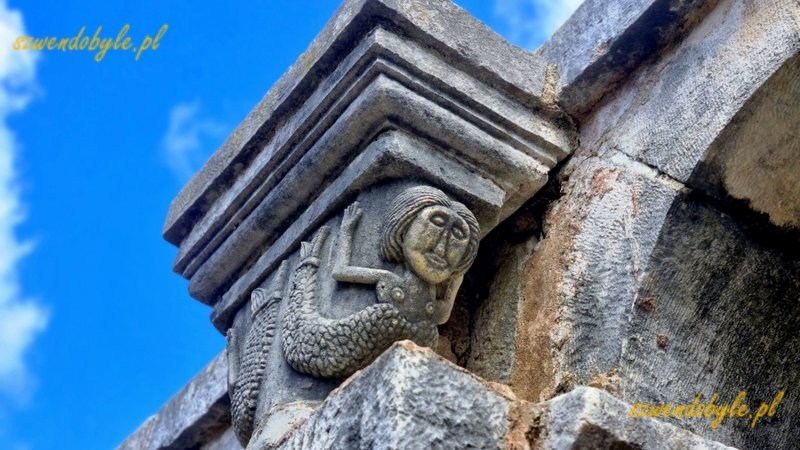 Albania, Apollonia Iliryjska. Fragment muru kościoła, do budowy wykorzystano bloki kamienne ze starożytnych budowli. Detal - na szczycie kolumny postać syreny. 20240504_145550-ink