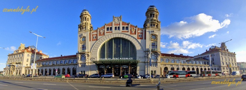 Praga dworzec gł&oacute;wny - Praha hlavn&iacute; n&aacute;draž&iacute;. Zdjęcie z zewnątrz, z drugiej strony ulicy Wilsonowej na gmach dworca charakterystycznymi wieżami. Zdjęcie panoramiczne całego gmachu. 20251228_143433-ink