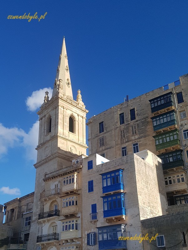 Balkony na Malcie, Valletta. Wieża kościoła i nagromadzenie balkonów okolicznych kamienic. Na pierwszym panie balkony niebieskie, z tyłu zielone na wyższej kamienicy.